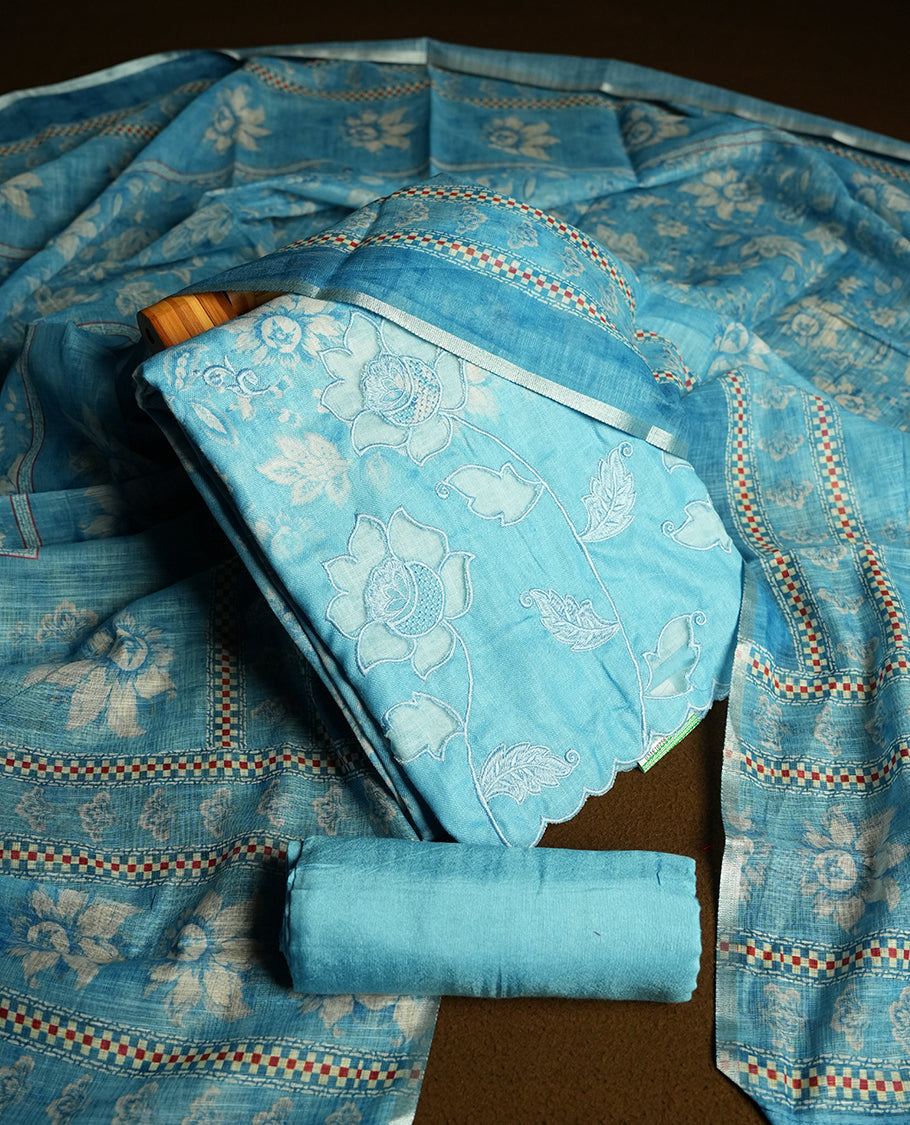 Blue colour churidhar material featuring floral and cutwork embroidery on the front panel, digital floral printed dupatta with elegant border, and matching plain bottom.