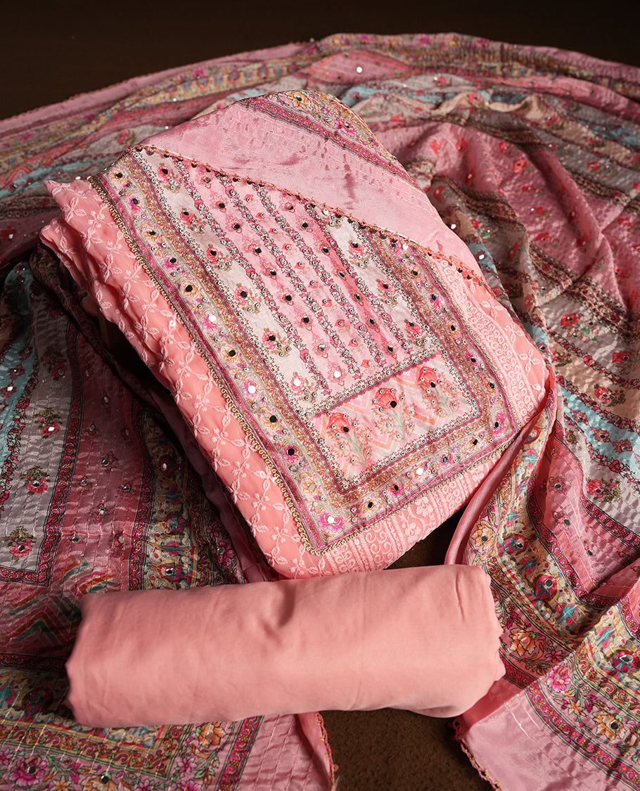 Pink colour churidhar material featuring Mirror and thread embroidery, foral print pattern on the self colour front panel, floral digital printed dupatta with elegant border, and matching plain bottom