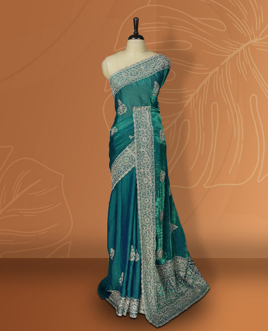 Double shaded Blue colour velvet chiffon designer saree in elegant two tone shades, featuring light gold zari, kodi work with handwoven style thread aari & dori embroidery work, Swarovski stone work and all over motifs, comes with matching blouse.