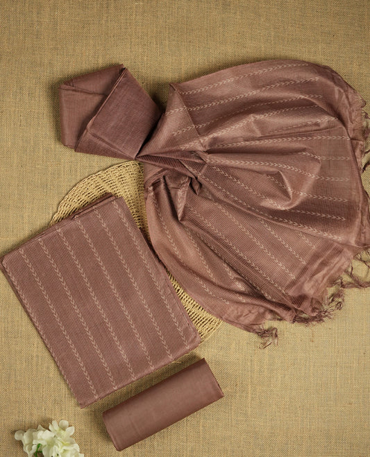 Dusty brown colour tussar suit material adorned with intricate woven patterns and subtle motifs, exuding ethnic elegance & Paired with a beautifully bordered dupatta and a matching plain bottom.