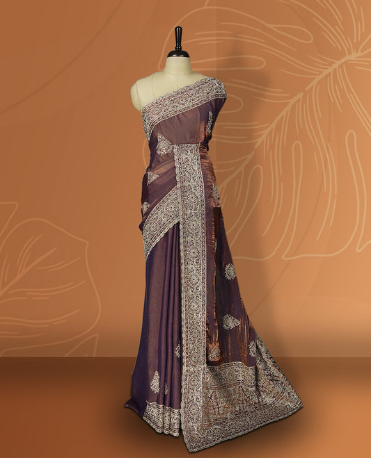 Double shaded Brown colour velvet chiffon designer saree in elegant two tone shades, featuring light gold zari, kodi work with handwoven style thread aari & dori embroidery work, Swarovski stone work and all over motifs, comes with matching blouse.