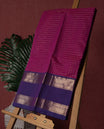 Magenta colour pure Kanchi cotton saree featuring with delicate golden checks on body, paired with a contrasting violet zari woven border & Includes a matching blouse piece for a complete look.