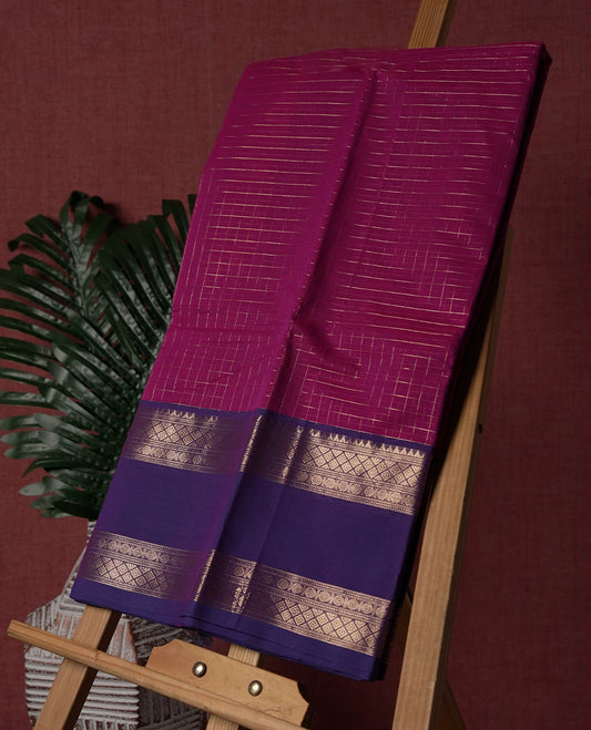 Magenta colour pure Kanchi cotton saree featuring with delicate golden checks on body, paired with a contrasting violet zari woven border & Includes a matching blouse piece for a complete look.
