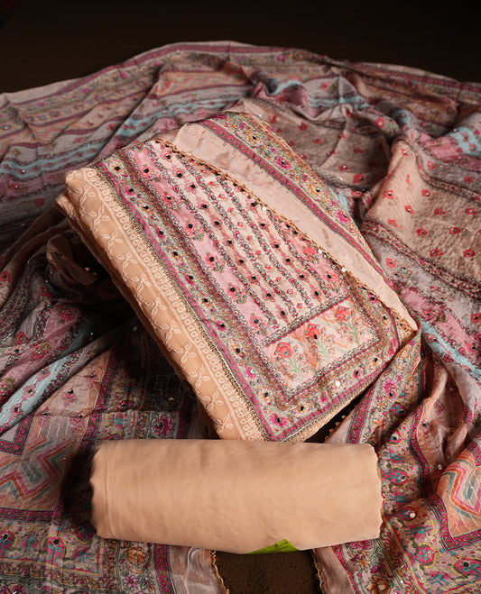 Peach colour churidhar material featuring Mirror and thread embroidery, foral print pattern on the self colour front panel, floral digital printed dupatta with elegant border, and matching plain bottom