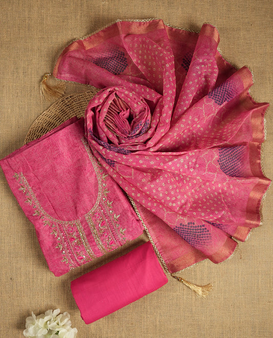 Dark pink colour suit material adorned with pearls, sequins and cut beads embroidery work on the neckline, exuding a graceful charm & Paired with a floral printed dupatta and a matching plain bottom.