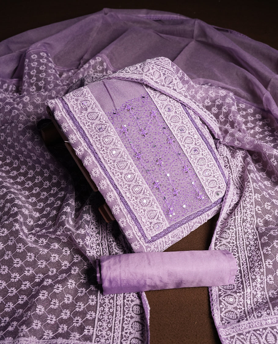 Lavender Churidar Material featuring Intricate Thread Embroidery with Mirror and Cut Beads Work on the Front Panel, paired with an All Over Embroidered Net Dupatta and Matching Bottom