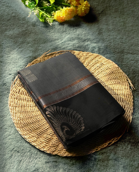 Black & Grey colour tissue cotton saree featuring elegant silver & copper zari motifs, a delicate zari border, and a beautifully woven pallu & Paired with a matching blouse, perfect for festive and traditional occasions.