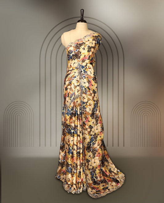 Yellow colour pure crepe saree with abstract floral print in earthy tones, highlighted by mirror work on the body and scalloped border, paired with a matching blouse.