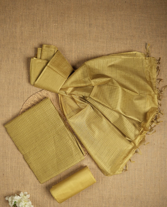Citrine yellow tussar suit material featuring a subtle self check woven pattern on the body, paired with a lightweight matching dupatta with tassel edges and a plain bottom piece.