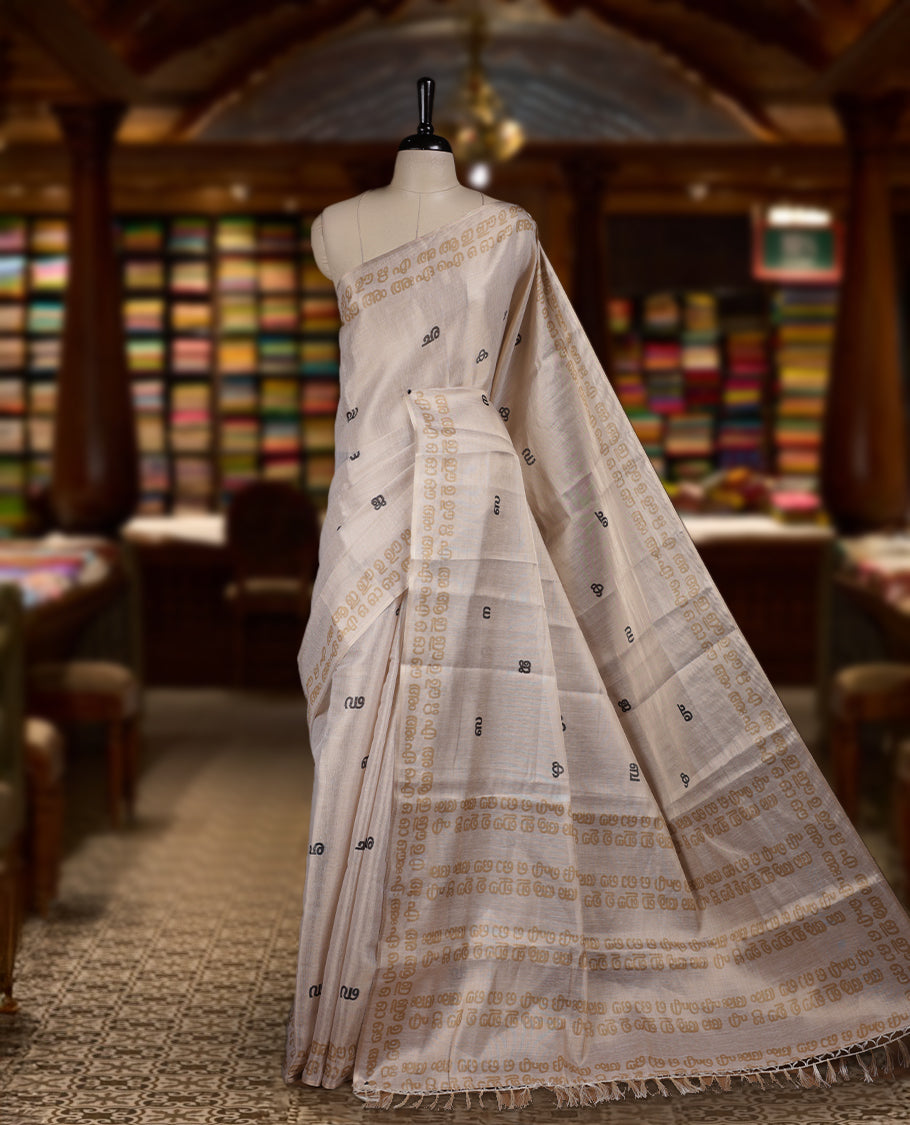 Beige colour Semi tissue saree adorned with Contrast colour digital script Design on the body and an elegant pallu & comes with a matching blouse piece