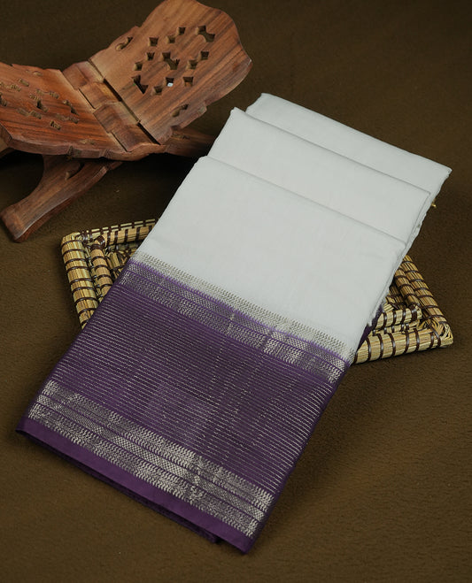 white colour mixed chanderi cotton saree with plain body, pallu featuring rose gold zari border, and matching deep purple blouse.
