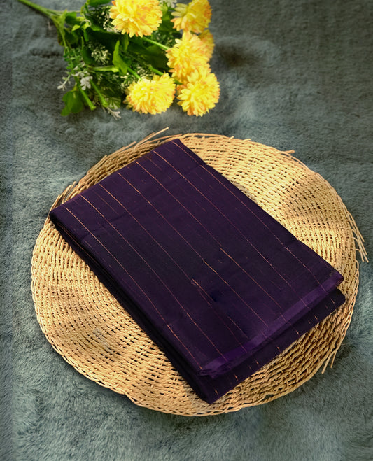 Dark violet colour silk cotton saree featuring with delicate vertical copper zari lines on the body, rich blue contrasted border & Crafted without a border for a classy touch, Comes with a matching blouse for a perfectly coordinated look.