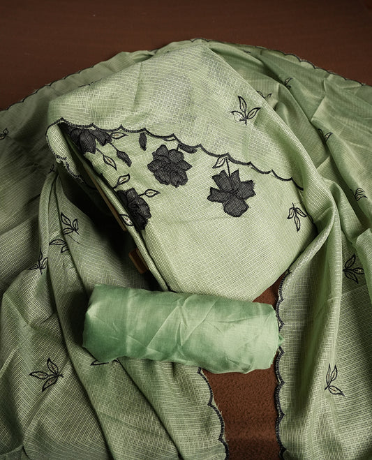 Green colour churidhar material featuring Black colour thread embroidery on the front panel, self colour dupatta with elegant border, and matching plain bottom