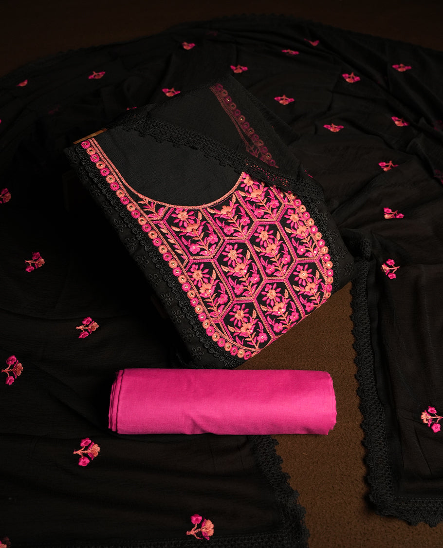 Black colour hakoba churidhar material featuring beautiful pink and peach colour floral embroidery on the neckline and front panel, highlighted with lace detailing & Comes with an embroidered dupatta and contrast pink colour bottom.