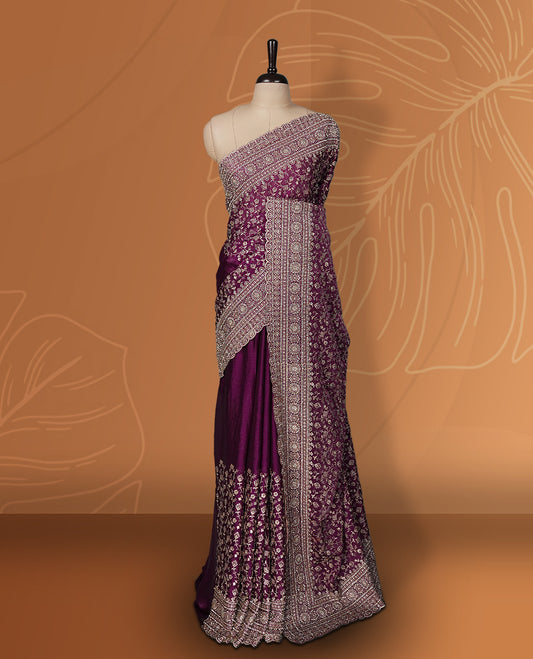 Magenta colour velvet chiffon designer saree in elegant two tone shades, featuring light gold zari, kodi work with handwoven style thread aari & dori embroidery work, Swarovski stone work and all over motifs, comes with matching blouse.