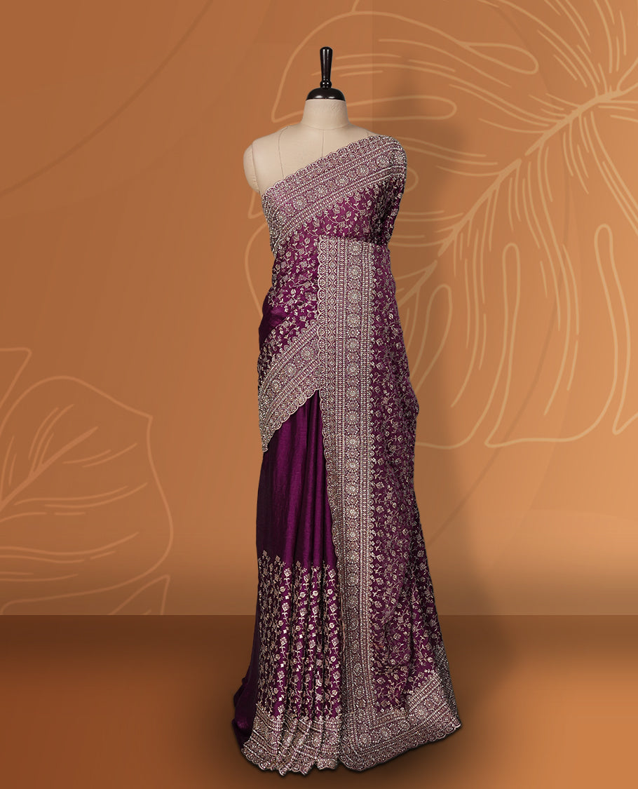 Magenta colour velvet chiffon designer saree in elegant two tone shades, featuring light gold zari, kodi work with handwoven style thread aari & dori embroidery work, Swarovski stone work and all over motifs, comes with matching blouse.