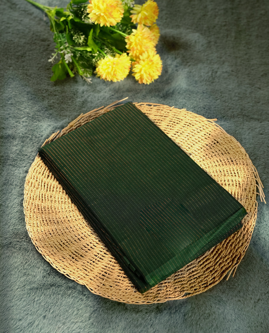 Dark green colour silk cotton saree featuring with full of delicate vertical copper zari lines on the body & green contrasted colour pallu, Crafted without a border for a classy touch, Comes with a matching blouse for a perfectly coordinated look.
