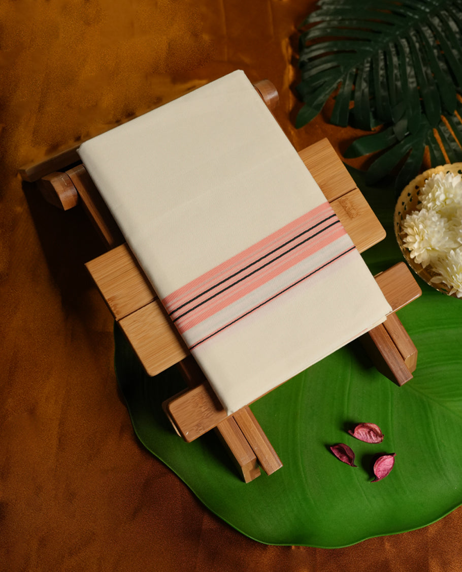 Cream colour cotton dhoti featuring a soft texture with a subtle peach border highlighted by fine black stripes, offering a classic yet stylish traditional look perfect for rituals, festive wear, and special occasions.