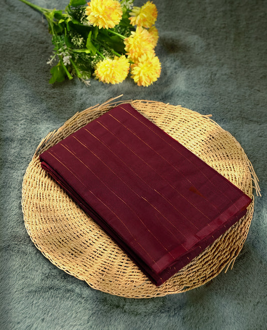 Maroon colour silk cotton saree featuring with delicate vertical copper zari lines on the body, Crafted without a border for a classy touch , Navy blue colour contrasted pallu & Comes with a matching blouse.