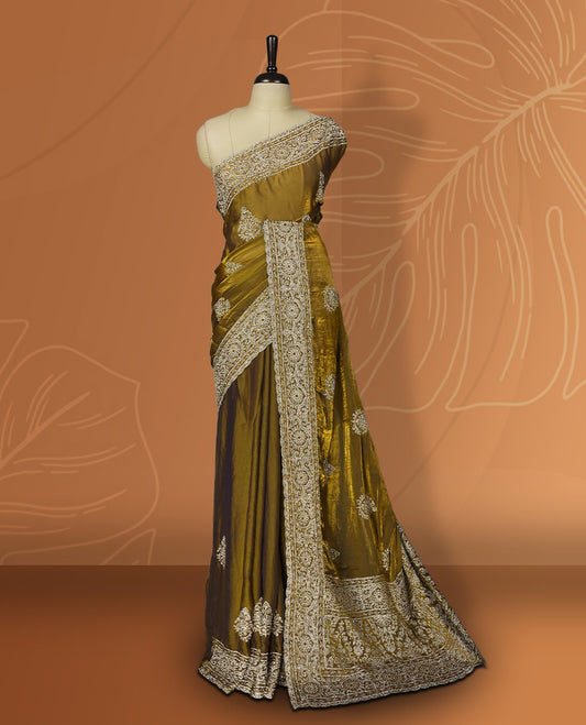 Dark yellow colour velvet chiffon designer saree in elegant two tone shades, featuring light gold zari, kodi work with handwoven style thread aari & dori embroidery work, Swarovski stone work and all over motifs, comes with matching blouse.