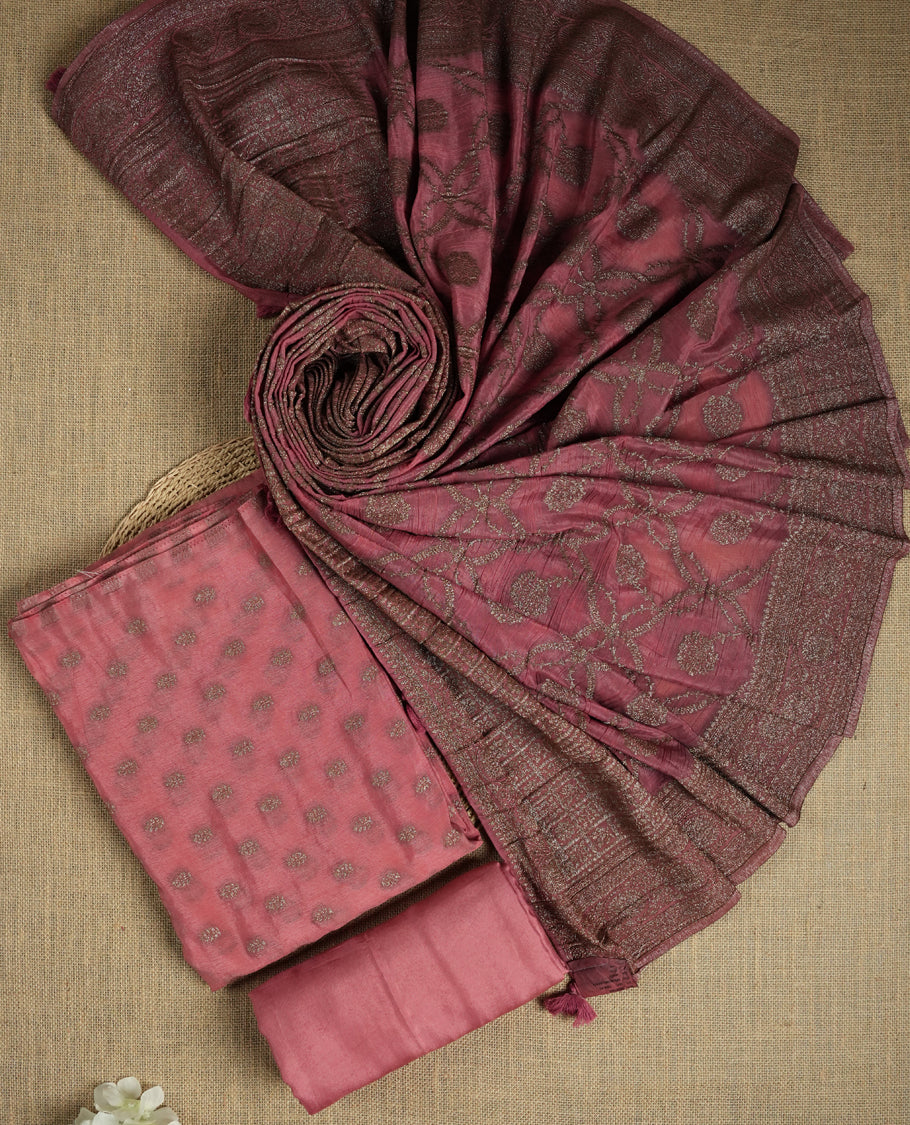 Dusty pink suit material adorned with delicate light copper toned zari work & Comes with a beautifully woven dupatta and matching plain bottom fabric.