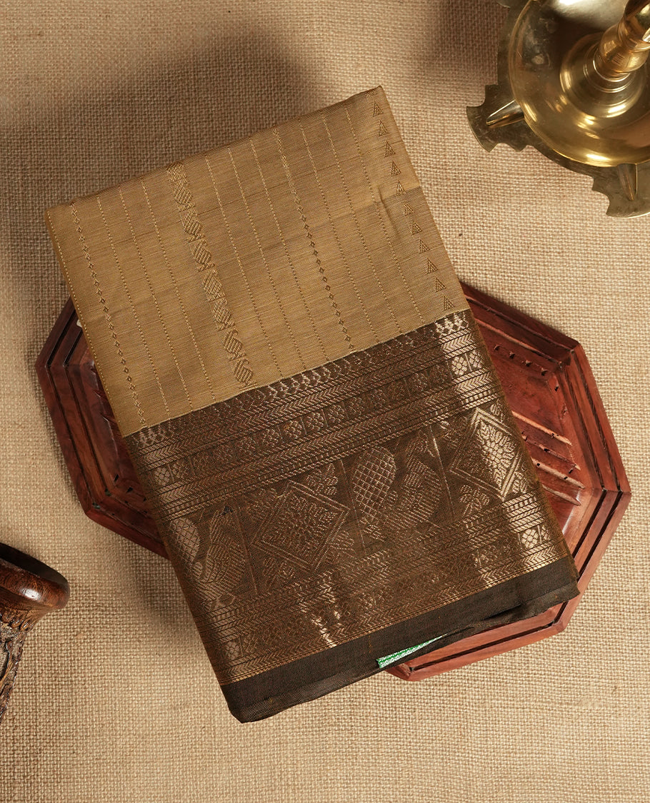 Pastel brown colour Chettinad cotton saree featuring small zari striped motifs on the body, complemented by a rich golden zari woven border with intricate traditional pattern & Comes with a matching blouse piece.