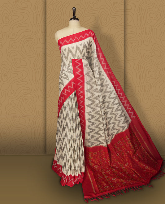 Off white colour Ikkat Pochampally saree with bold grey colour zigzag motifs and contrasting maroon borders, The striking woven pallu enhances its elegance, making it a perfect blend of tradition and style, Paired with a matching blouse.
