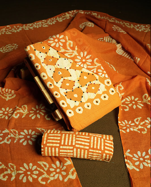 Mustard yellow & Off white cotton churidar material adorned with thread work on the neckline, featuring traditional tie dye patterns and a stripped body & Comes with a matching printed dupatta and coordinated printed fabric for the bottom.