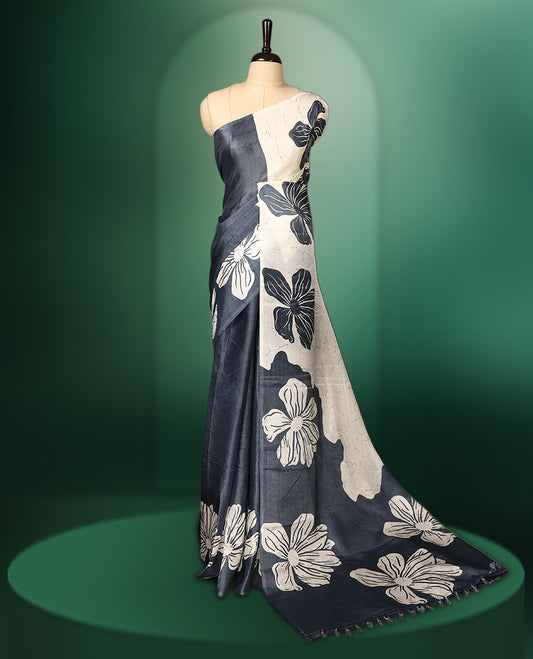 White and grey double shade semi tussar saree adorned with bold floral motifs across the body, designed without a border for a contemporary touch, and paired with a matching blouse