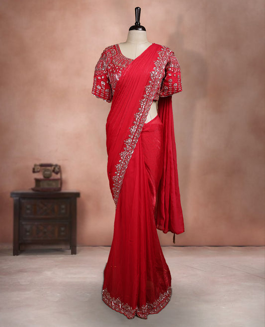 Elegant Deep Red ready to wear saree adorned with rich silver zari and bead embroidery along the border and pallu, paired with a heavily embellished matching blouse for a grand festive look.