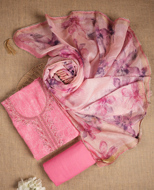 Pink colour suit material adorned with sequins and cut beads embroidery work on the neckline, exuding a graceful charm & Paired with a floral printed dupatta and a matching plain bottom.