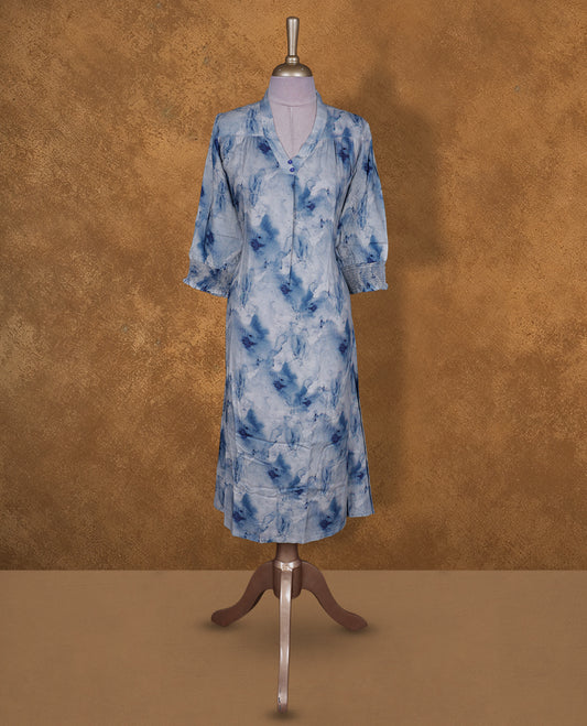 Light blue colour tie dye kurti BY VISMAY with darker blue floral accents, straight calf length silhouette, featuring a V notch neckline and three quarter sleeves with gathered cuffs.