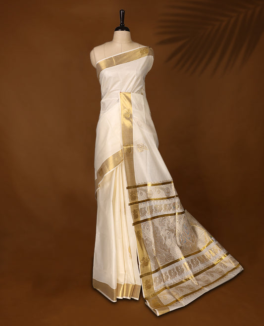 Elegant Kerala Kasavu saree with a golden border and intricately woven pallu, The ivory base adds a touch of grace, perfect for festive occasions, Style with a contrast blouse for a timeless traditional look.