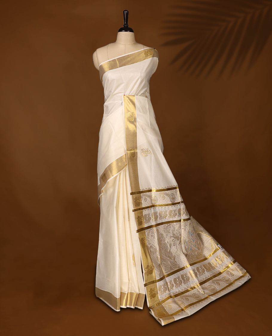 Elegant Kerala Kasavu saree with a golden border and intricately woven pallu, The ivory base adds a touch of grace, perfect for festive occasions, Style with a contrast blouse for a timeless traditional look.