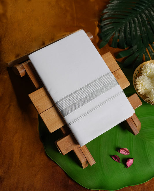 White colour cotton dhoti with elegant silver zari borders, combining tradition with style & Perfect for weddings, festivals, and spiritual occasions, offering comfort with a refined ethnic touch.