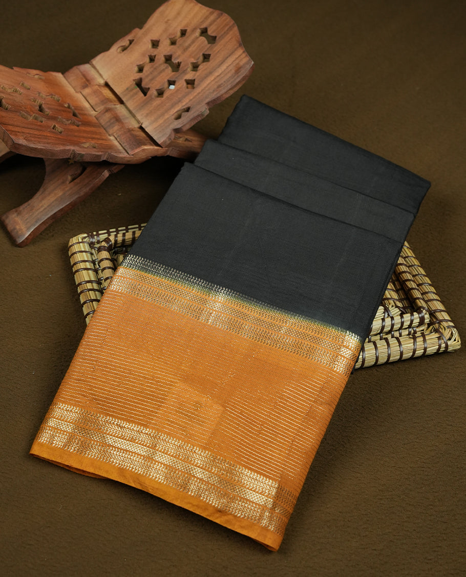 Black chanderi cotton saree featuring plain body, mustard orange pallu with gold zari border, matching mustard orange blouse.