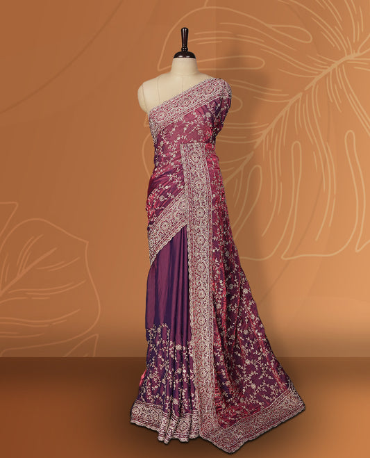 Purple colour velvet chiffon designer saree in elegant two tone shades, featuring light gold zari, kodi work with handwoven style thread embroidery, Swarovski stone work and all over motifs, comes with matching blouse.