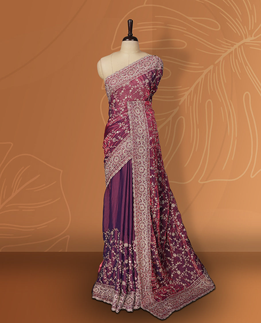 Purple colour velvet chiffon designer saree in elegant two tone shades, featuring light gold zari, kodi work with handwoven style thread embroidery, Swarovski stone work and all over motifs, comes with matching blouse.