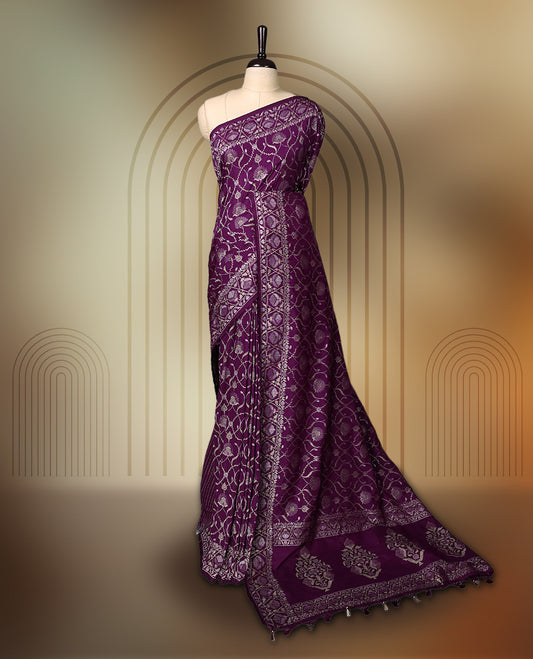 Rich purple Banaras soft silk saree with all over silver zari floral vines, ornate woven border, and bold pallu with paisley motifs. Comes with a matching blouse & Ideal for weddings and festive occasions.