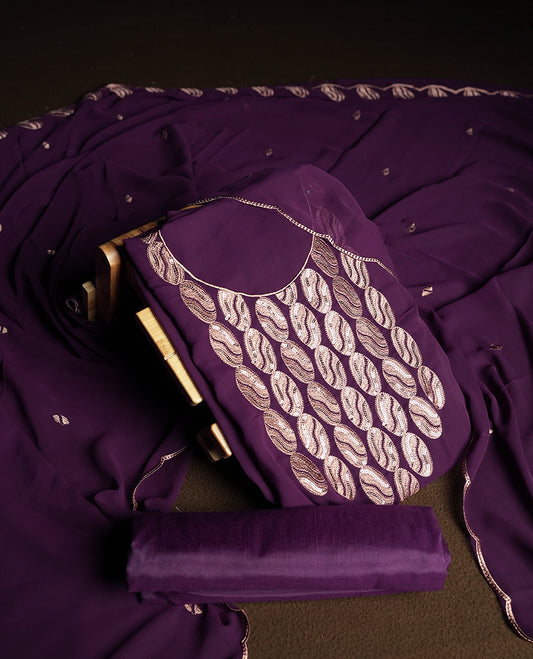 Dark violet colour churidar material adorned with intricate sequin embroidery on the neckline and body & Accompanied by a matching embroidered dupatta and plain bottom.