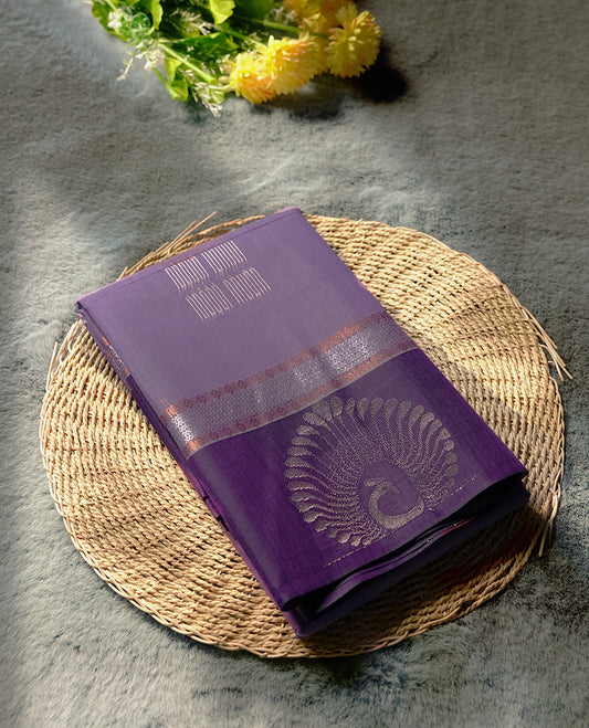 Purple colour tissue cotton saree featuring elegant silver & copper zari motifs, a delicate zari border, and a beautifully woven pallu & Paired with a matching blouse, perfect for festive and traditional occasions.