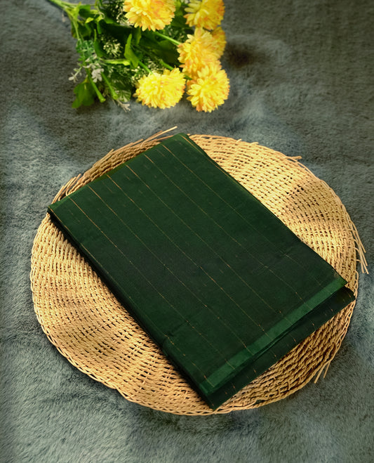 Dark green colour silk cotton saree featuring with delicate vertical copper zari lines on the body, Crafted without a border for a classy touch, Comes with a matching blouse for a perfectly coordinated look.