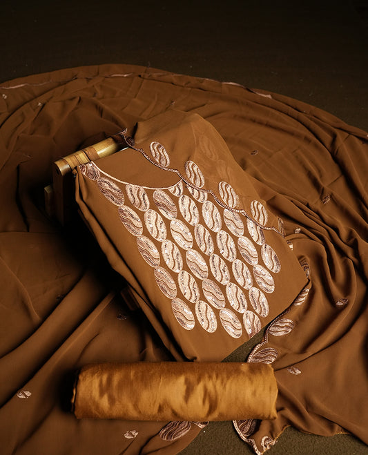 Mustard brown colour churidar material adorned with intricate sequin embroidery on the neckline and body & Accompanied by a matching embroidered dupatta and plain bottom.