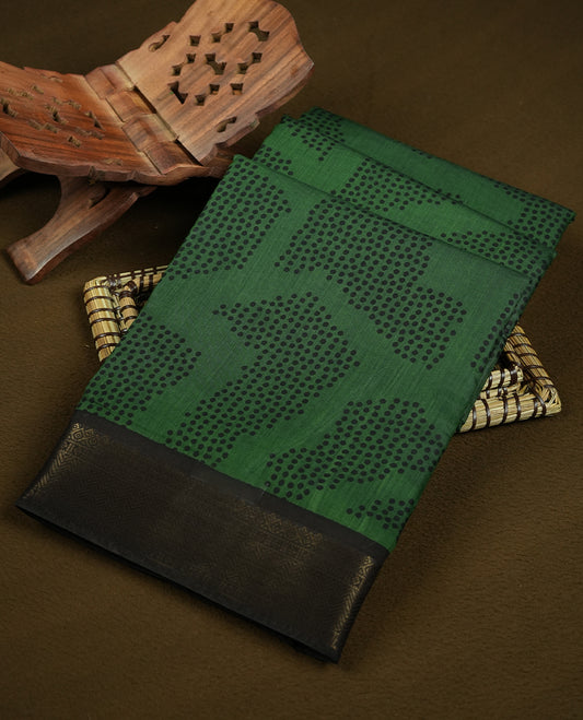 Green colour mixed chanderi cotton saree with black dotted square motifs, black and golden zari border with triangle geometric pattern, striped pallu, and matching green blouse