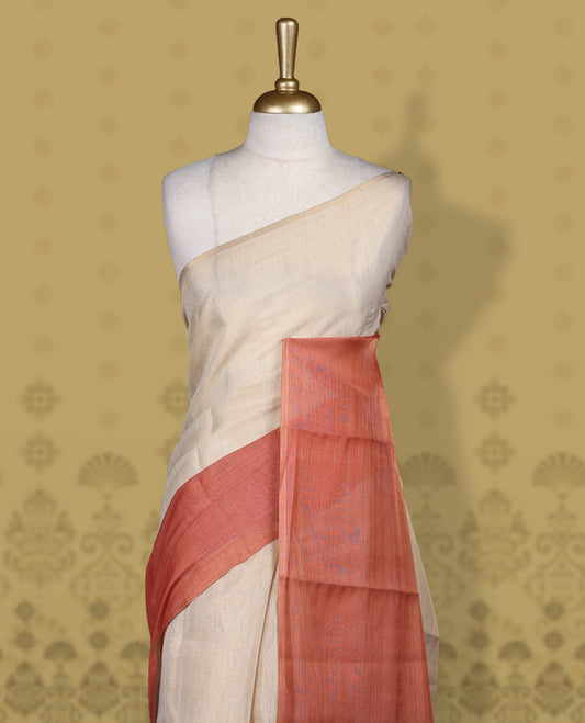 Beige and rust orange colour saree, featuring a smooth woven texture, The shaded rust pallu adds a refined charm & Finished with tassel detailing and comes with a matching blouse piece.