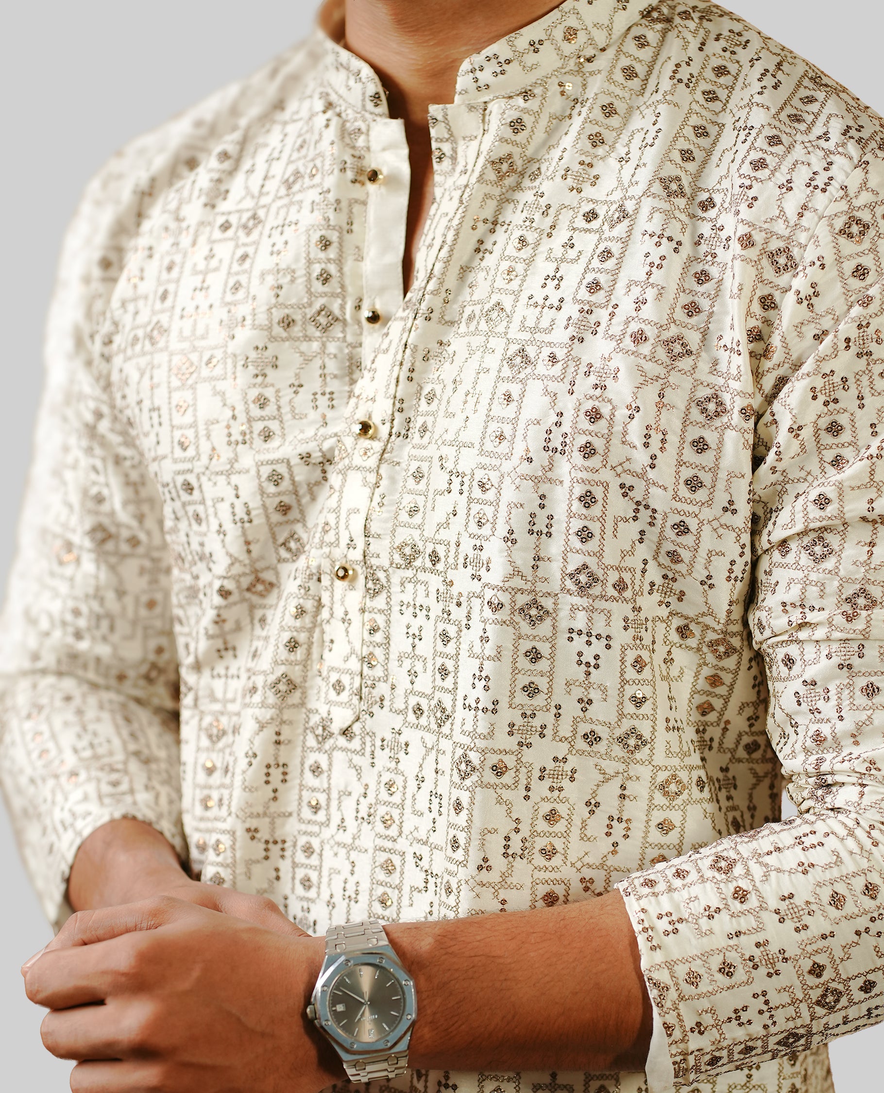 Off white colour men's kurta featuring elegant thread and sequins work on the body, complemented by full sleeves for a refined and festive look.