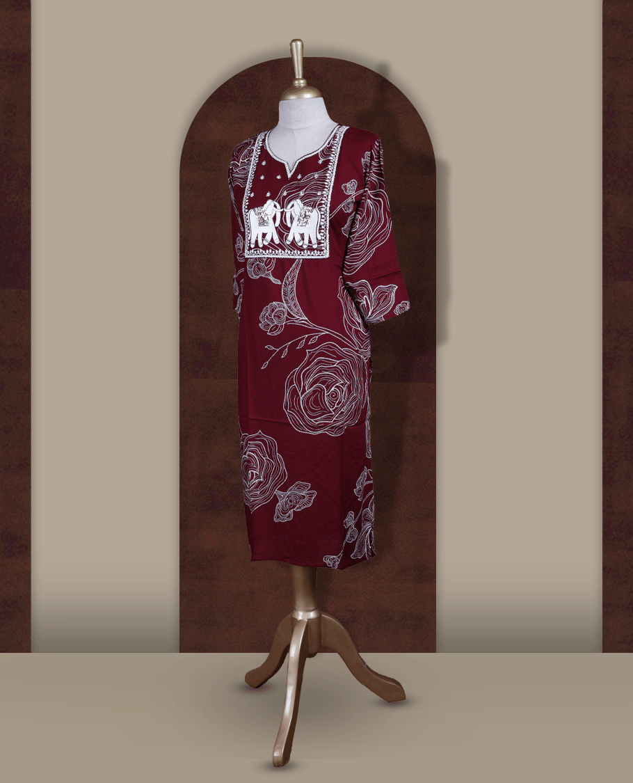Maroon colour kurti featuring a square embroidered neck design with elephant motif patchwork, V-cut neckline, 3/4th sleeves, and floral printed body.
