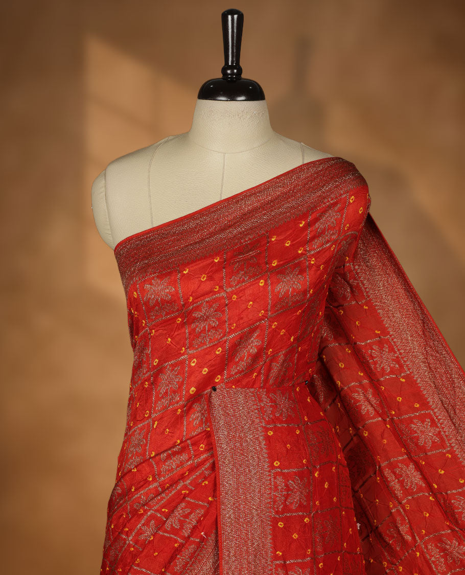 Reddish orange colour Banarasi Bandhani silk saree featuring with intricate Banarasi motifs on body, complemented by antique zari woven border and grand pallu, paired with matching  blouse
