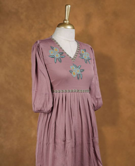 Dusty mauve knee-length A-line dress with V-neckline, pastel floral embroidery on yoke and scalloped hem, and elbow-length gathered sleeves.