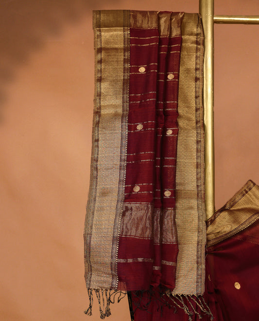 Maroon coloured Maheshwari Cotton saree featuring antique Zari Round motifs across the entire body, complemented by a traditional gold coloured border and a matching blouse.